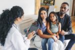 Young family getting medical consultation from doctor on house call